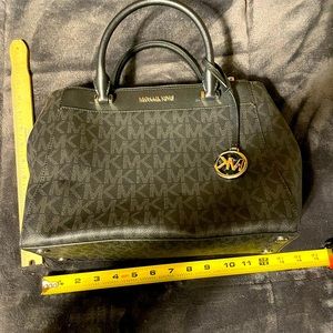 Michael Kors black with gray MK. Like new, no stains or rips. No shoulder strap